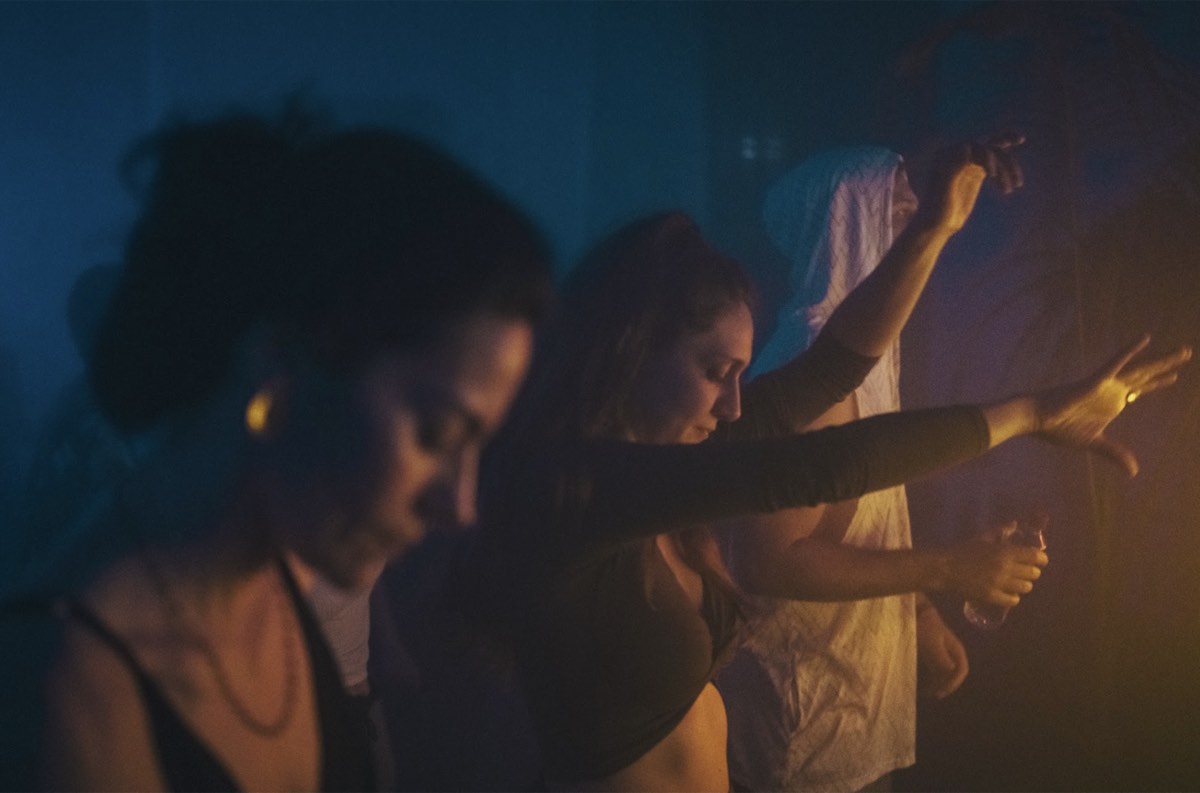 Dancers moving under blue stage lights at spring equinox festival Lisbon