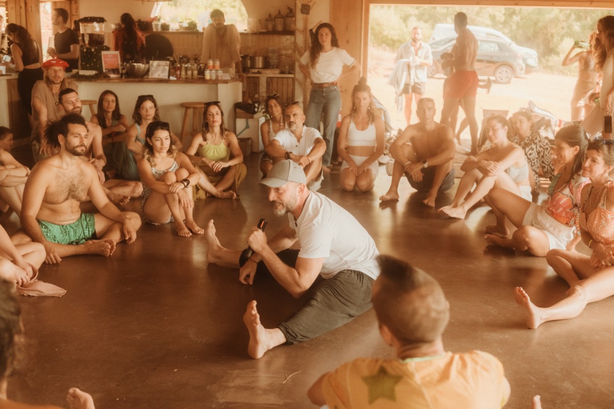 Group circle sharing session at ecstatic dance gathering near Lisbon